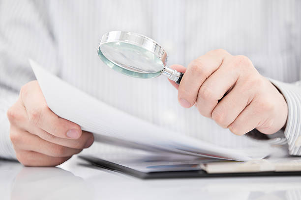 istock Businessman looking through a magnifying glass 465697245