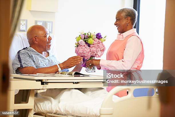 Volunteer Worker Tidying Male Patients Hospital Room Stock Photo - Download Image Now