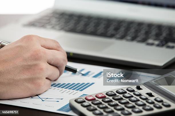 Businessman Analyzing Investment Charts Stock Photo - Download Image Now - Adult, Balance, Banking