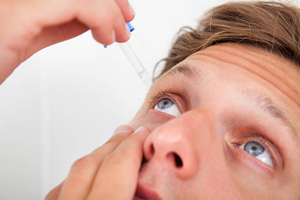 istock Young Man Putting Eye Drops In His Eyes 465702067