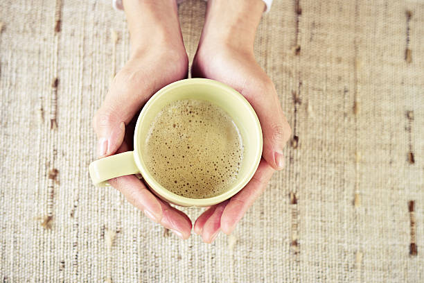 istock hands holding cup of coffee 465702900