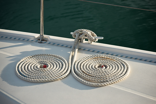 A mooring ropes with a knotted ends tied around a cleat