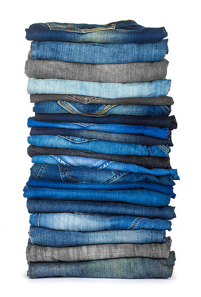 istock stack of different shades of blue jeans on a white background 465703562