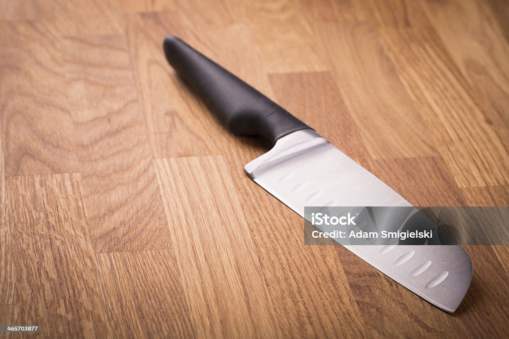 Santoku knife very sharp brand new kitchen knife with large blade on wooden chopping block Bamboo - Material Stock Photo