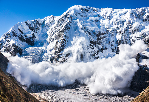 Real huge avalanche comes from a big mountain (Shkhara, 5,193 m), Caucasus, Kabardino-Balkaria, Bezengi region, Russia