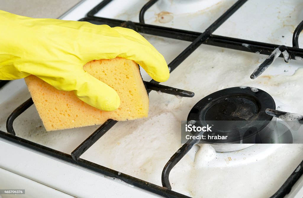 cleaning of dirty gas stove burner cleaning of dirty gas stove burners in kitchen room 2015 Stock Photo