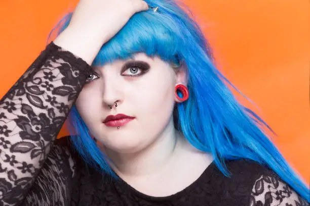 Photo of Young girl with blue hair and piercings