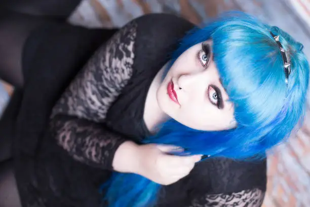 Photo of Young girl with blue hair and piercings