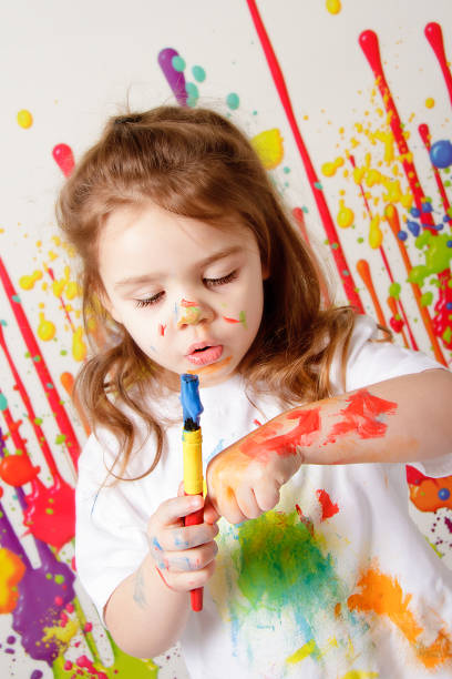 istock Little girl covered in paint 465706462