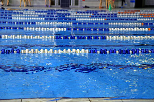 istock indoor swimming pool with blue water 465707076