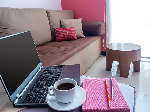 laptop with coffee cup on couch in modern Living room