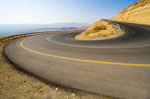 A hairpin bend on a road in the mountains of the negev desert in Israel