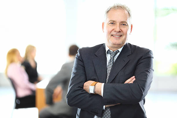 istock Smiling senior businessman and his team. 465711533