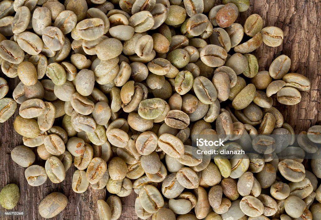 green coffee beans on wooden surface 2015 Stock Photo