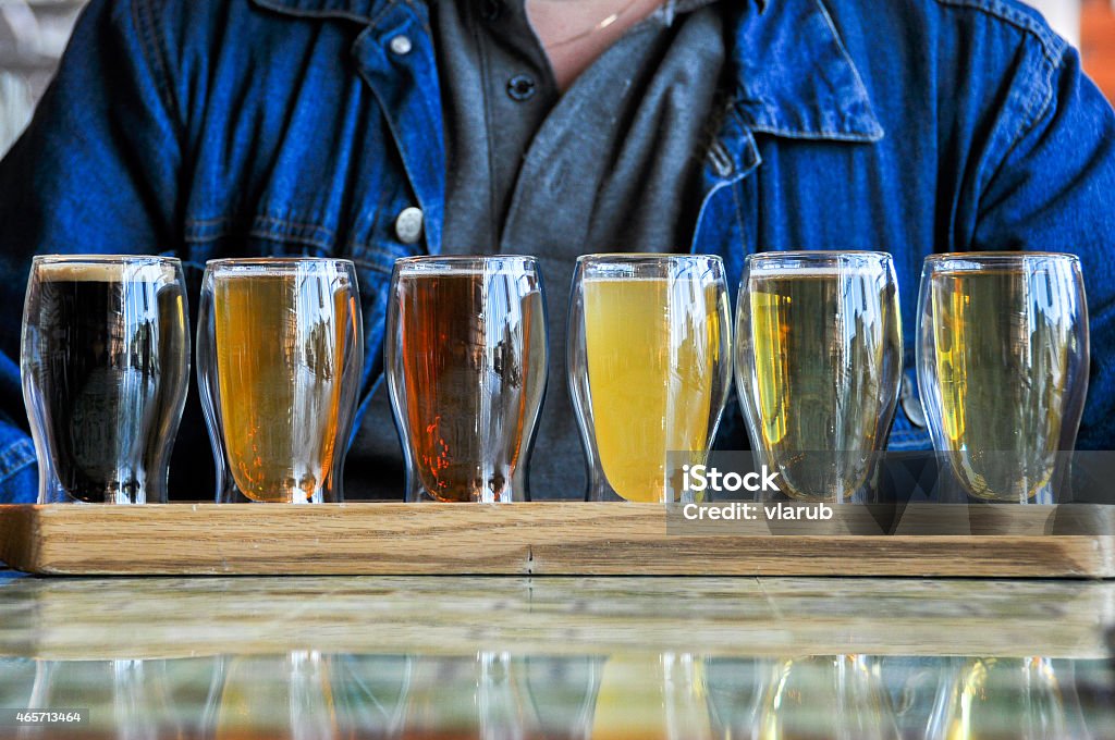 glasses of Beers glasses of the different Beers on wood desk Tasting Stock Photo