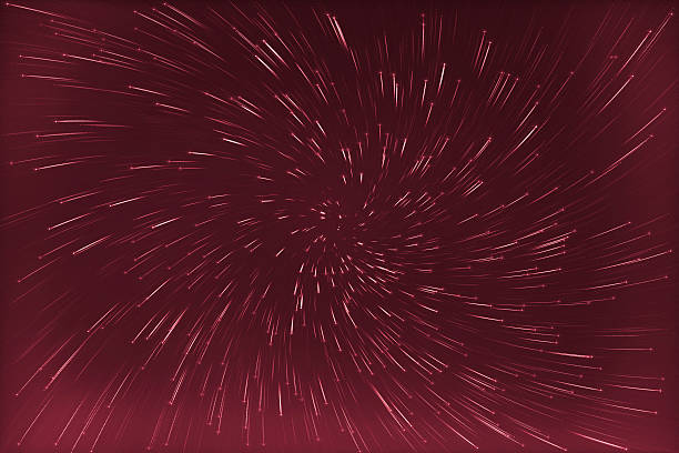 abstract long exposure of vortex star trails background  red colorized abstract long exposure of vortex star trails background  red colorized long shutter speed stock pictures, royalty-free photos & images