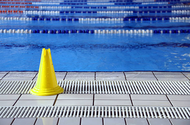 istock wet floor cone signal in the big pool 465713796