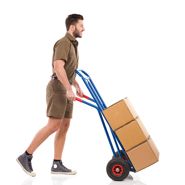 istock Courier walking with a delivery cart 465714174
