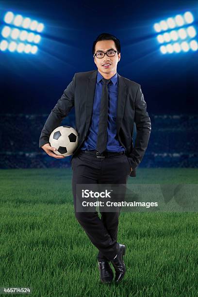Male Manager With Football At Field Stock Photo - Download Image Now - 2015, Adult, Adults Only