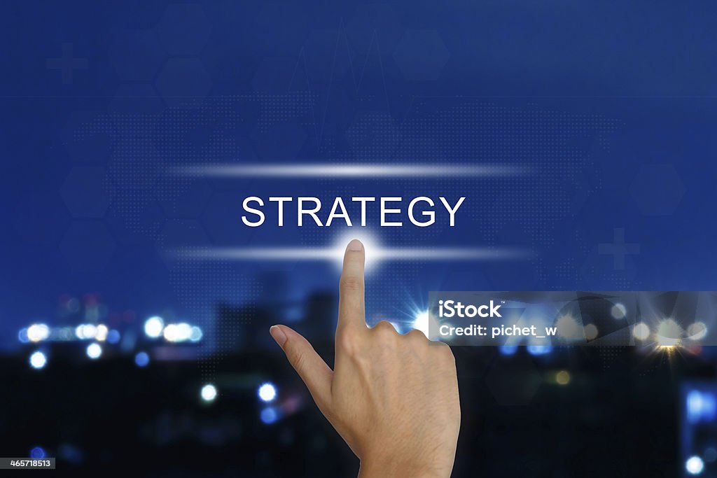 hand pushing strategy button on touch screen hand clicking strategy button on a touch screen interface Achievement Stock Photo