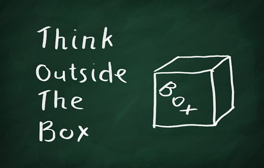 Think Outside the Box Concept drawn with Chalk on Blackboard