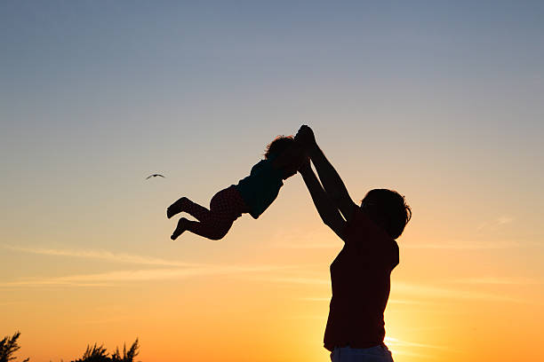 istock Father and little daughter playing at sunset 465733576