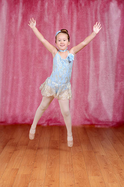 istock Little ballerina jumping in blue tutu 465734925