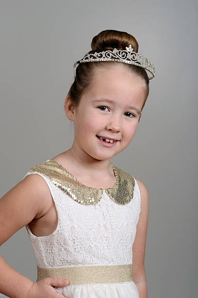 istock little girl wearing princess crown 465734931