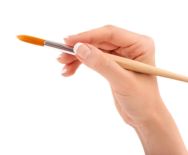 istock Female hand holding paint brush isolated 465736889