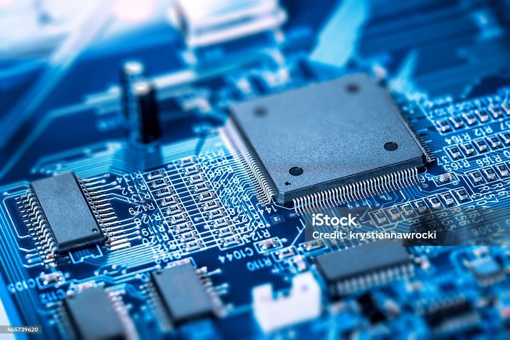 Microprocessor on blue circuit board Electronic blue Circuit Board. Focus on main large chip.  Semiconductor Stock Photo