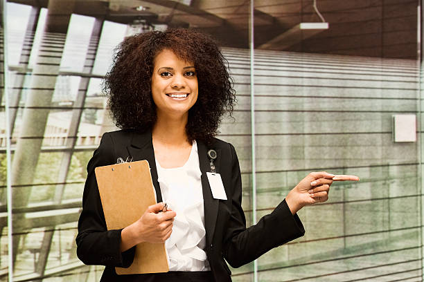 istock Smiling businesswoman in office and pointing 465742130