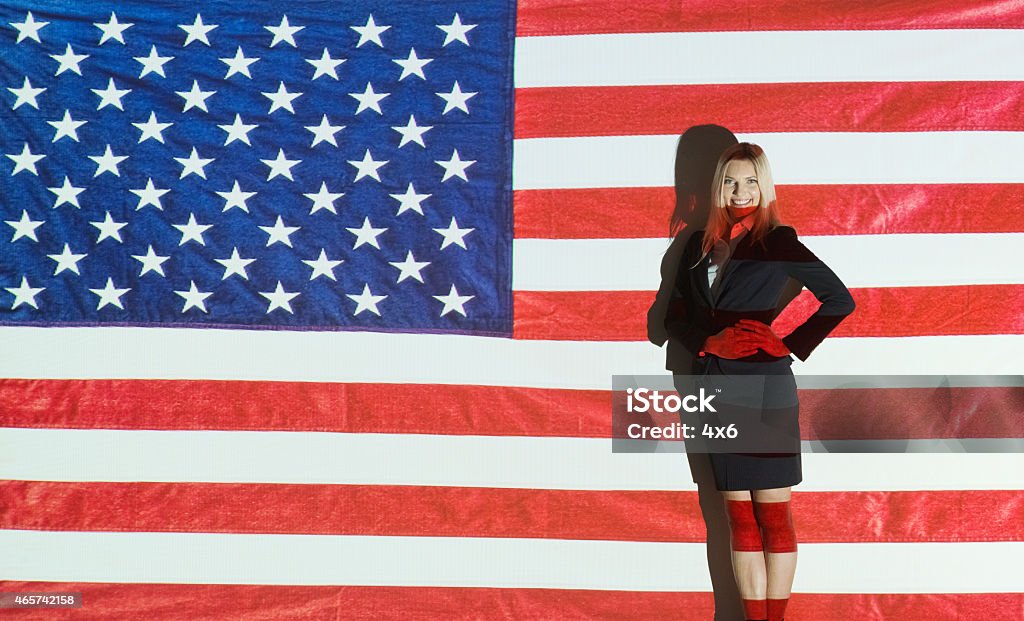 Smiling businesswoman in front of American flag Smiling businesswoman in front of American flaghttp://www.twodozendesign.info/i/1.png 2015 Stock Photo