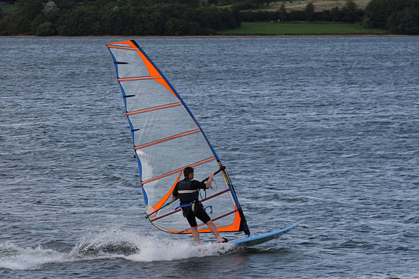 istock windsurfer on a lake with a blue sail 465742660