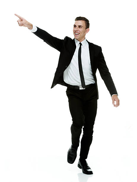 istock Smiling businessman walking and pointing away 465746412