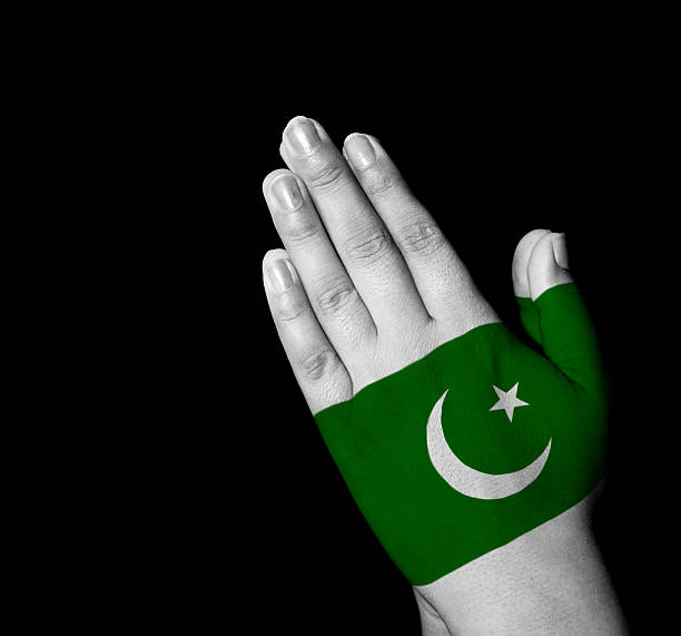 Hands folded in prayer - Pakistan flag painted on hands - Digitally generated