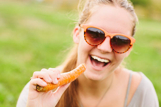 istock Smiling Girl Eating a Carrot 465746826