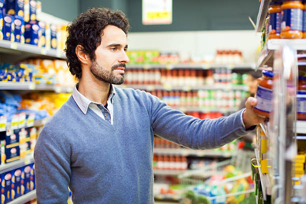 istock Attractive young man shopping in a supermarket 465746842