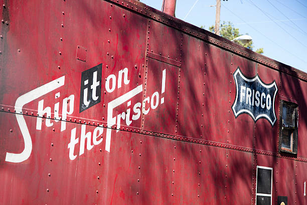Frisco train car. Railroad station, old-fashioned, antique shipping container. Jewett, Texas, USA - February 14, 2015: The Frisco Lines was an old train line that ran from St. Louis, Missouri to San Francisco, California, beginning in the 1800s.  The St. Louis to San Francisco Railway was made up of a number of smaller roads, including the old Southwest Branch, the Pacific Railroad and the KCM&B, with its General Office in St. Louis.  Before the Civil War, however, the Frisco and Santa Fe operated jointly into San Francisco.  The company owners combined the letters “FR” from Francisco, the “IS from part of St. Louis, and the “CO” for Company, which produced the name Frisco Lines.  frisco texas stock pictures, royalty-free photos & images