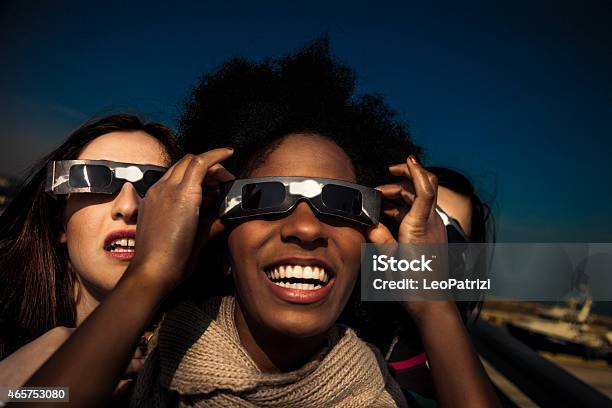 Group Of Friends Looking To A Solar Eclipse Stock Photo - Download Image  Now - Eclipse, Eyeglasses, Friendship - iStock