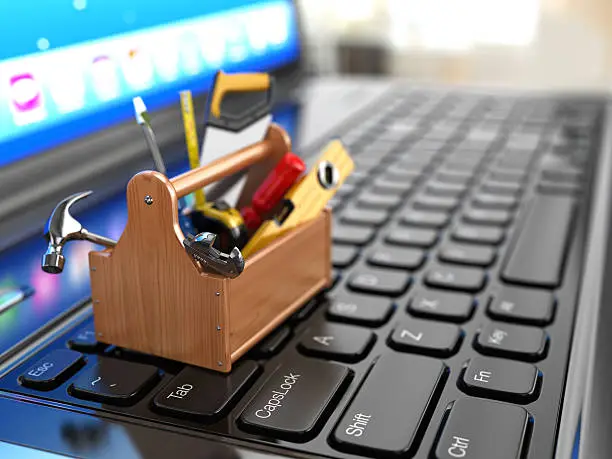 Photo of Online support. Toolbox with tools on laptop.