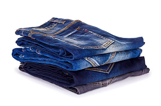 istock stack of different shades of blue jeans on a white background 465755452