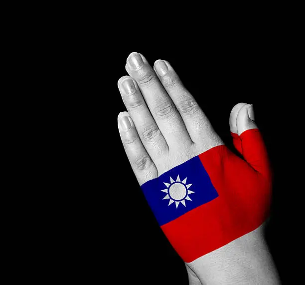 Hands folded in prayer - Republic-of-China flag painted on hands - Digitally generated