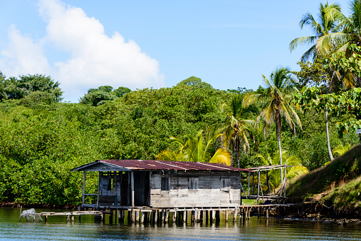 Small rustic house built on stilts along the shore on the islands of Bocas del Toro, Panama