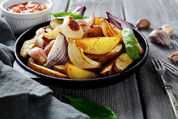 istock Baked potatoes with garlic and sauce on a wooden surface 465762224