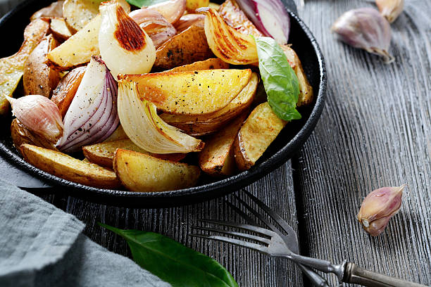 istock Tasty baked potatoes with basil in the pan 465762258