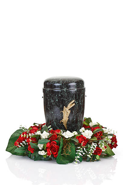 istock Black urn and floral wreath on white background 465762340