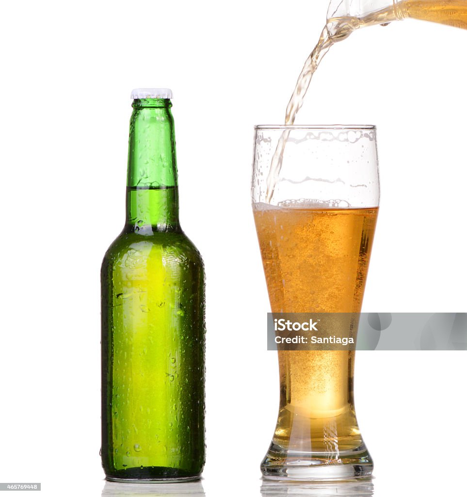 Pouring beer from bottle isolated on white background 2015 Stock Photo