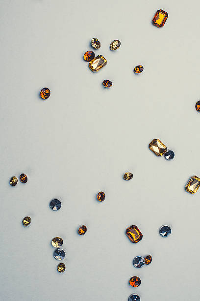 istock Close up of orange rhinestones gems 465772130