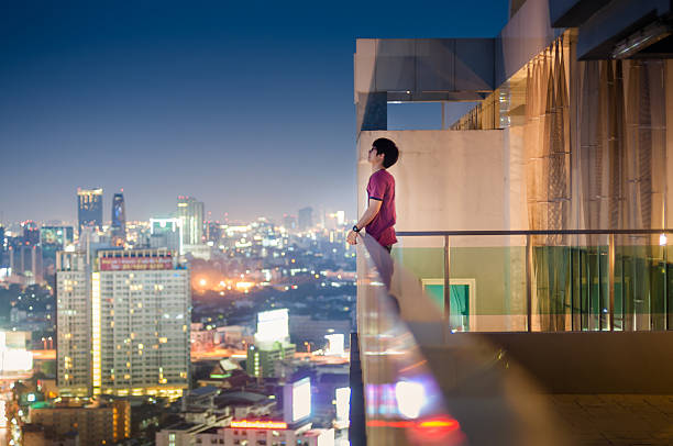 istock Men standing on the rooftop of a skyscraper over  cityscape 465772698