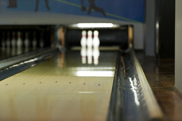 Ten Pin Bowling Bowling Ball Focused And At The End, The Pins Waiting For The Shot bowling alley wood stock pictures, royalty-free photos & images
